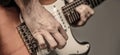 Close up hand playing guitar. Musician playing guitar, live music. Musical instrument. Electric guitar. Repetition of Royalty Free Stock Photo