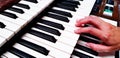 Close up hand playing piano or press elect tone keyboard. Royalty Free Stock Photo