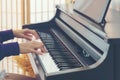 Close up hand playing the piano. Teen Woman relaxing and playing the piano in the livingroom.