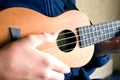 Close-up of a hand playing a ukulele