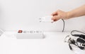 Close-up of hand plugging a plug into a multiple socket Royalty Free Stock Photo