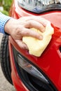 Close Up Of Hand Polishing Car Using Cloth