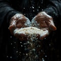 Close-up of a hand pouring sand through fingers symbolizing time Royalty Free Stock Photo