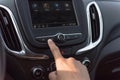 Male hand press the Previous button on modern car dashboard