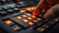 Close-up of a hand pressing illuminated buttons on a sleek control panel in a dark environment Royalty Free Stock Photo