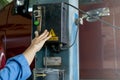 Close up hand push the button of car lifting machine in workplace of garage