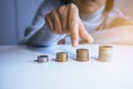 Close up of hand putting coins stacks on a table Royalty Free Stock Photo