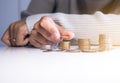 Close up of hand putting coins stacks on a table,Saving money concept Royalty Free Stock Photo