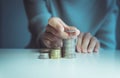 Close up of hand putting coins stacks on a table,Saving money concept Royalty Free Stock Photo