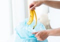 Close up of hand putting food waste to rubbish bag Royalty Free Stock Photo