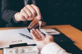 Close up of hand real estate agent passes the key to new homeowners in office Royalty Free Stock Photo