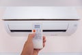 Close up hand and remote control air condition Royalty Free Stock Photo