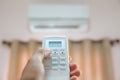 Close up hand and remote control air condition Royalty Free Stock Photo