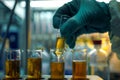 Close up the hand of Scientist takes samples of factory wastewater in a test tube for analysis in lab Banner size