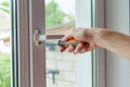 Close-up, hand with a screwdriver tightens the fixing of the window limite Royalty Free Stock Photo