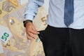 Man turns up his trouser pocket. Background of 50 euro in the background. Royalty Free Stock Photo