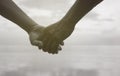 Close up hand of senior couple holding hand together near seaside at the beach,black and white picture color Royalty Free Stock Photo