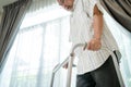 Close up hand of Senior disabled man walk with walker at nursing home. Asian Older elderly handicapped male patient have weak leg