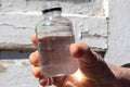 Close up of a hand of a senior woman holding a bottle of water in a sunny day Royalty Free Stock Photo