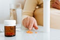 Close-up hand of senior woman patient counting pills, capsules of medicines lying on table. Royalty Free Stock Photo