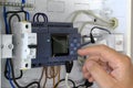 Close up of a hand setting up a PLC. Testing and programming of an industrial control system Royalty Free Stock Photo