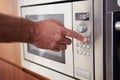 Close Up Of Hand Setting Timer On Microwave Oven Royalty Free Stock Photo