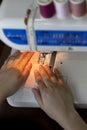 Close up sewing hand fabric with white sewing machine and thread Royalty Free Stock Photo