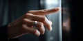 Close-up of a hand with a silver ring pressing a button on a dark modern elevator panel in low light Royalty Free Stock Photo