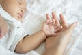 Close-up hand the sleeping baby in the hand of mother on the bed Royalty Free Stock Photo