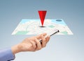 Close up of hand with smartphone and navigator map Royalty Free Stock Photo