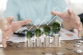 Close up of hand stacking gold coins with green bokeh background ,Business Finance and Money concept Royalty Free Stock Photo