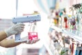 Close up hand of staff wearing gloves using portable usb nano sanitizer spray disinfectant machine fogger for covid19 in the shop