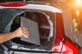 Hand stealing laptop from back side of car which rear glass broken Royalty Free Stock Photo