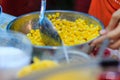 Close up hand of street vendor during cooking for mixed corn but