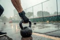 close-up hand on strong grip on kettlebell in rainy workout setting - generated by ai Royalty Free Stock Photo