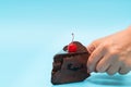 Close-up of hand taking a piece of chocolate cake Royalty Free Stock Photo