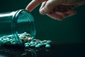 Close up of hand taking pills from a glass jar. Focus on foreground, Macro shot of pills being poured into a hand from a Royalty Free Stock Photo