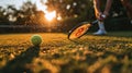 close up of hand with tennis racket and tennisball on green summer grass field