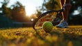 close up of hand with tennis racket and tennisball on green summer grass field