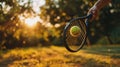 close up of hand with tennis racket and tennisball on green summer grass field Royalty Free Stock Photo