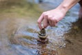 Close up hand to doing Stone stacked in water river Royalty Free Stock Photo