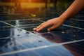 Close up A hand touches a solar panel, symbolizing renewable energy for climate change