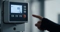 Close-Up of Hand Touching Digital Control Panel with Display Showing Numerical Data with Black Suit and Blurred Industrial Royalty Free Stock Photo