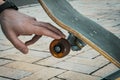 Close up of hand touching skateboard wheel Royalty Free Stock Photo