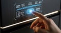 A human finger interacts with a futuristic digital display on a modern appliance showing various data points and graphics Royalty Free Stock Photo