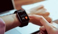 Close up of hand touching smartwatch with health app on the screen. Royalty Free Stock Photo