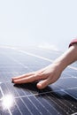 Close-up of a hand touching a solar panel