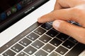 Close-up hand touching touch bar on macbook pro 2016