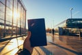 Close-up of the hand of a traveler using a passport at the railway station. Traveling by rail