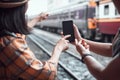 Close up hand. Travelers use smartphones to view maps and inquire about travel by pointing out places. at Hua Lamphong train Royalty Free Stock Photo